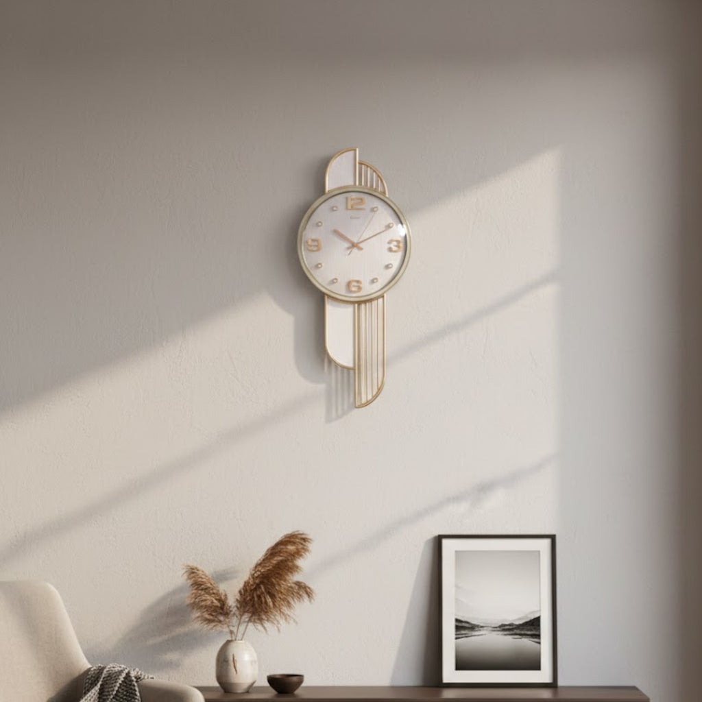 Decorative wall clock on a wall with a framed picture and plant in the foreground